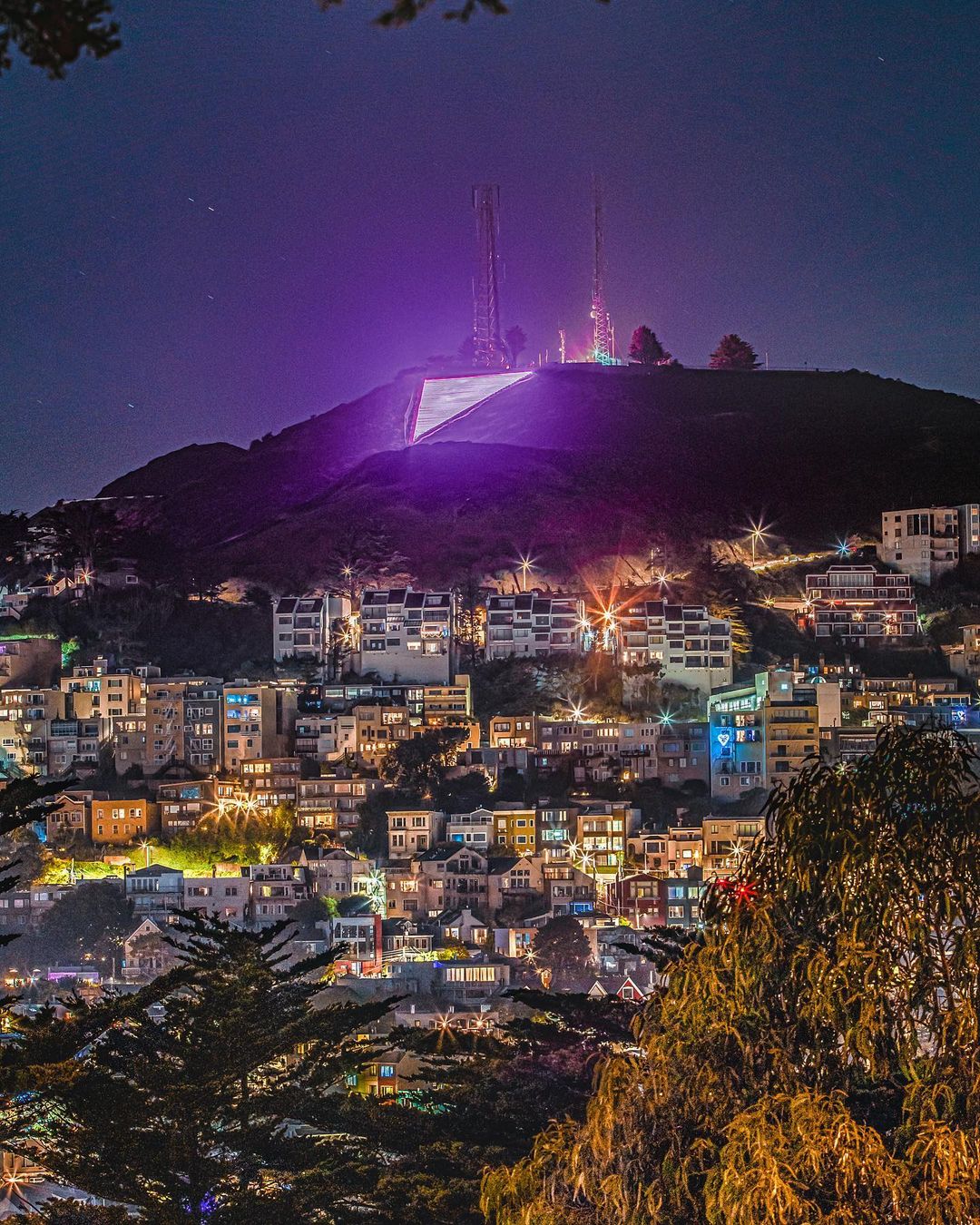 Pink triangle glows at the top of Twin Peaks.