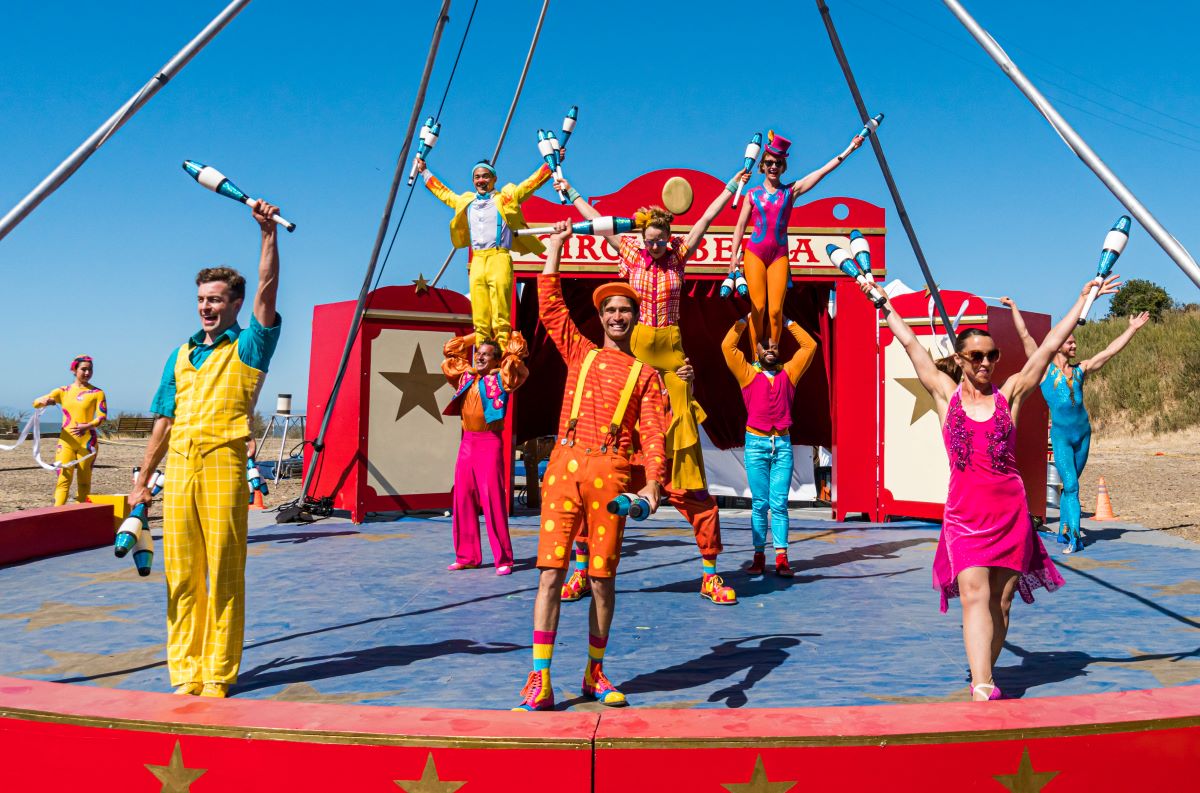 Circus Bella company waves to the audience from their outdoor performance ring.