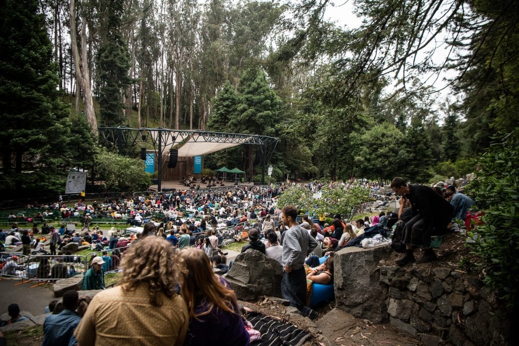 A crowd of people watches a concert at Stern Grove Festival.
