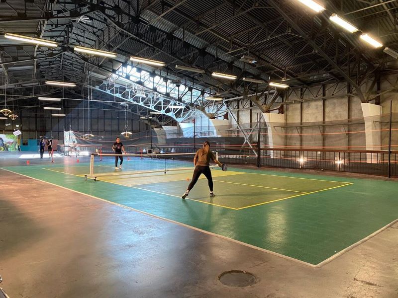 People play pickleball on indoor courts at SF's Palace of Fine Arts