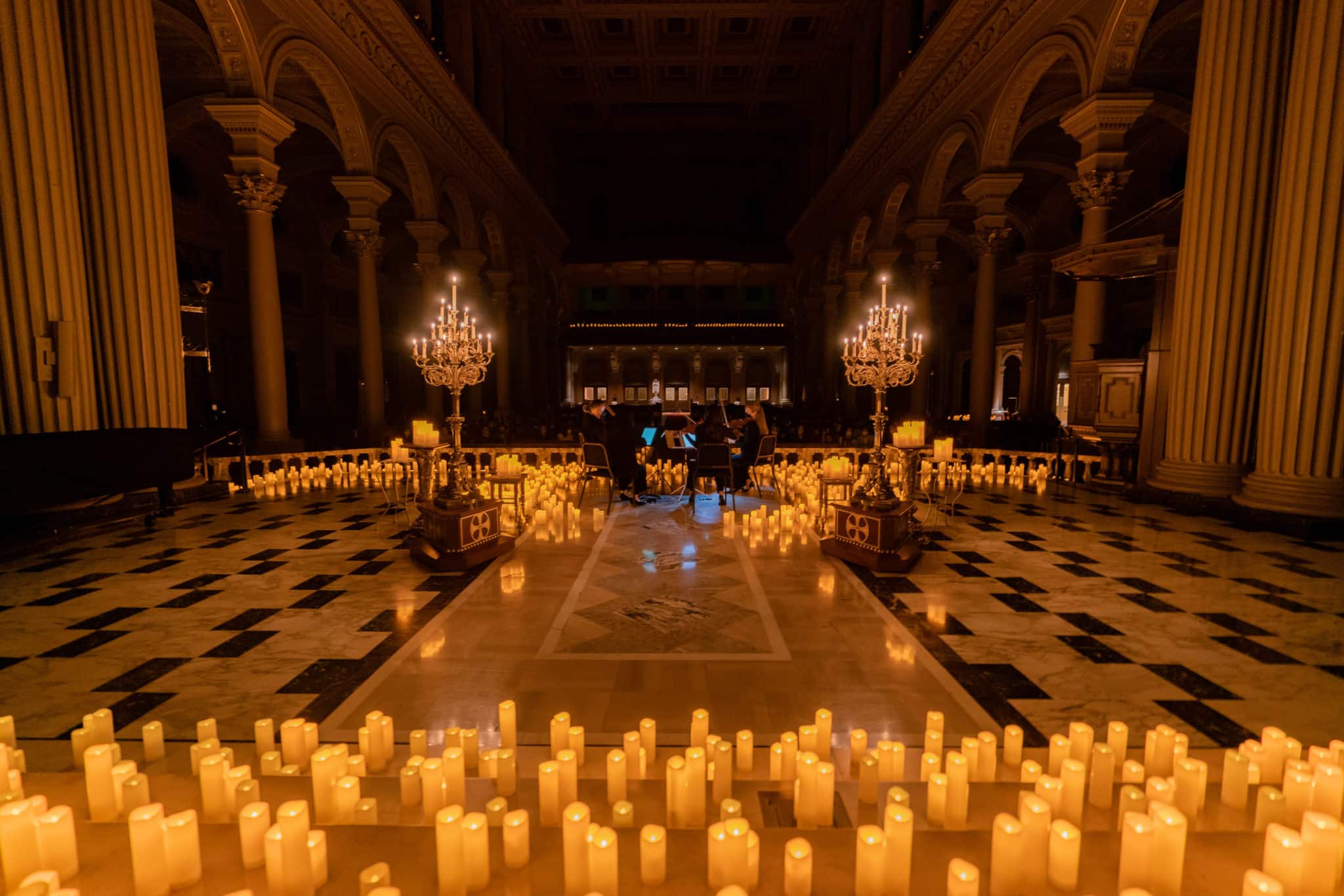 A wide shot of candles inside St Ignatius Church at one of the Candlelight concerts in San Francisco.