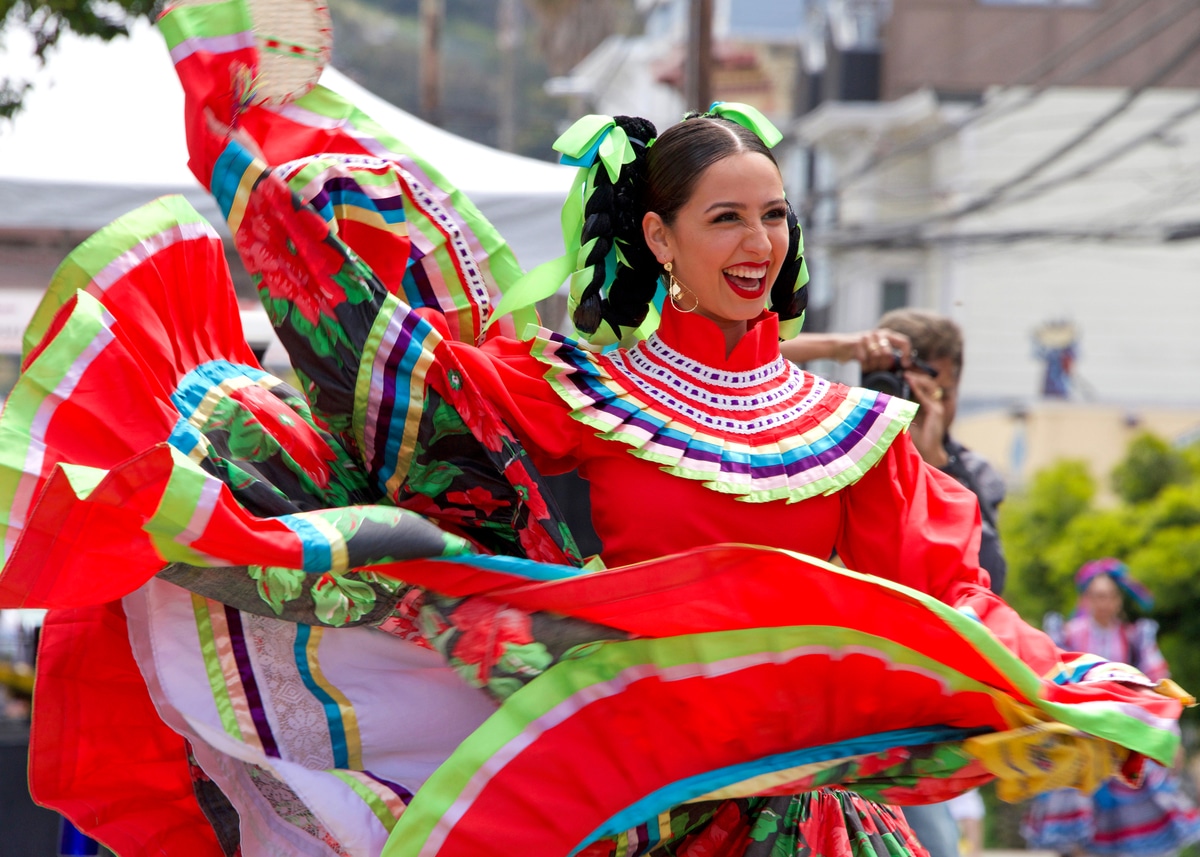 A dancer in a red Folklórico dress performs at San Francisco's 2019 Carnaval festival.