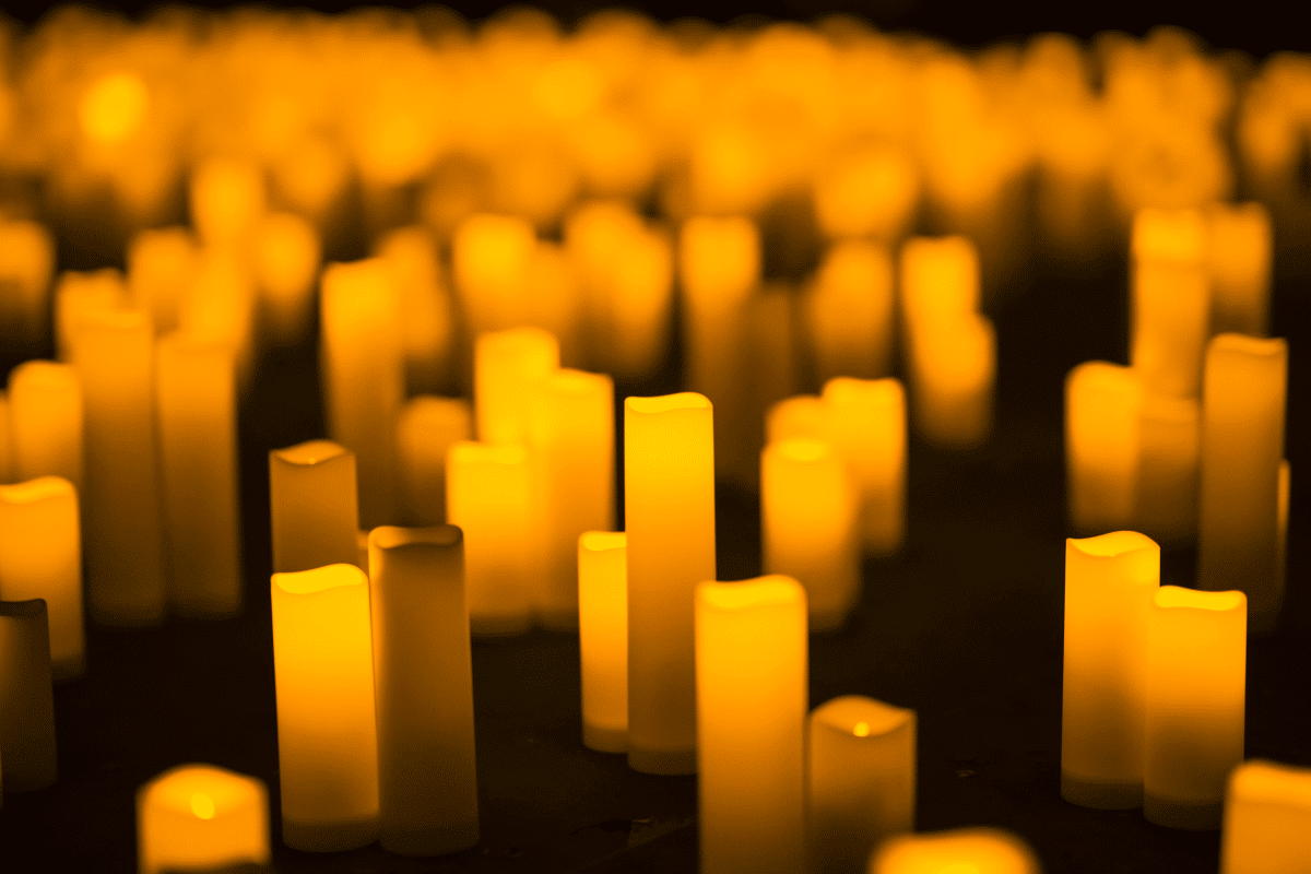 A close up of candles on display on the ground for a Candlelight concert.