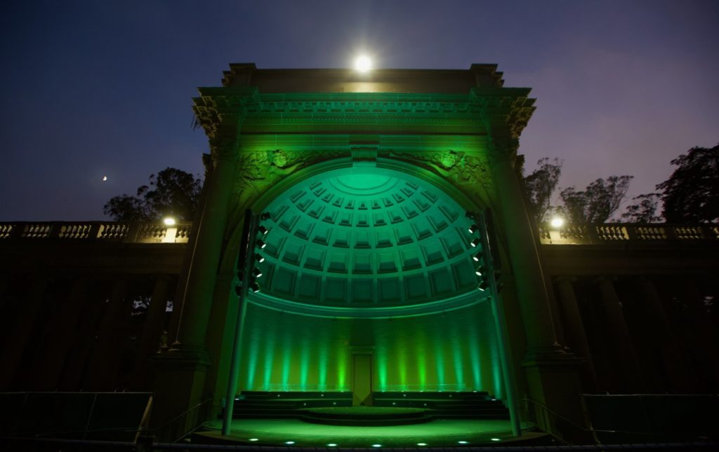 Golden Gate Park Bandshell illuminated in green lights.