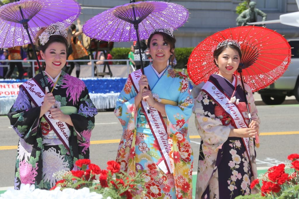 3 members of the Cherry Blossom Queen program pose for a photo at 2016's Northern California Cherry Blossom Festival in San Francisco.