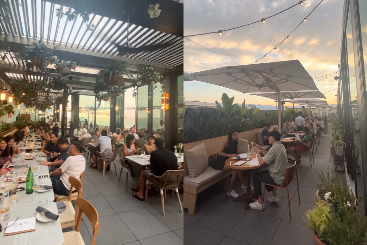 Diners seated on Eataly's packed rooftop at sunset.