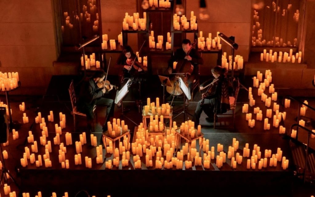 String quartet surrounded by candles