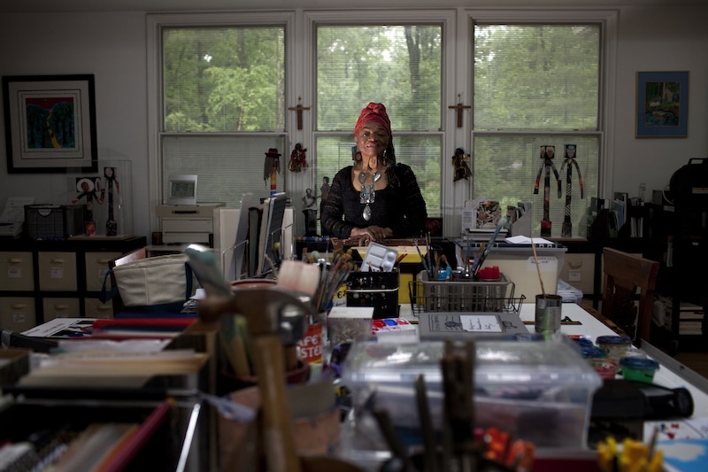 Artist Faith Ringgold seated in her studio