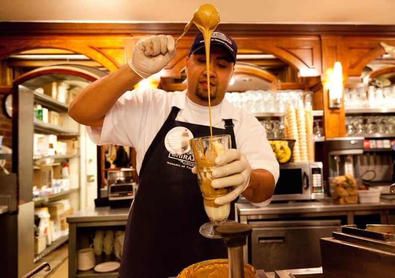 A Ghirardelli chocolatier makes a specialty sundae