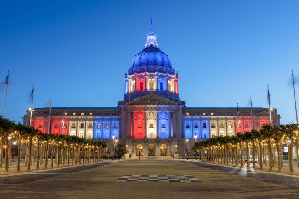 SF City Hall illuminated in red, white, and blue.
