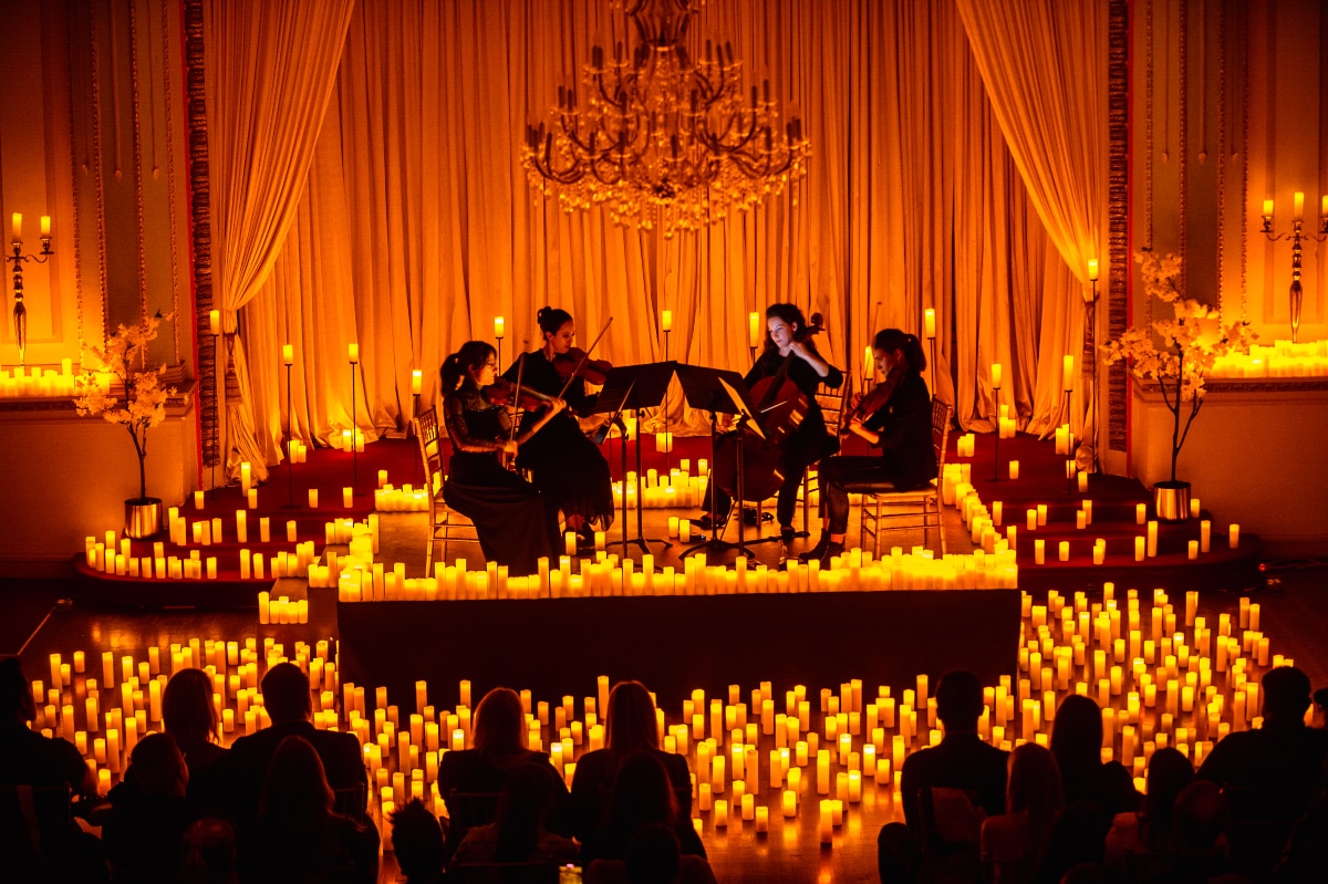 Musicians playing a Candlelight concert illuminated by candles