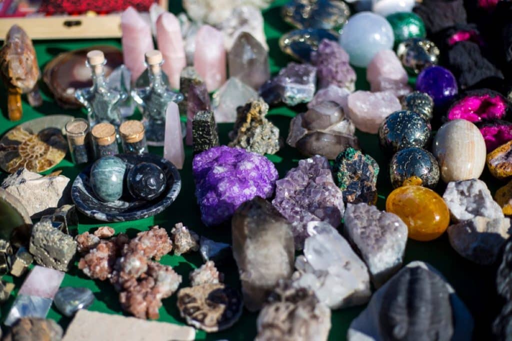 Assorted colorful crystals and gems laid out on a table.