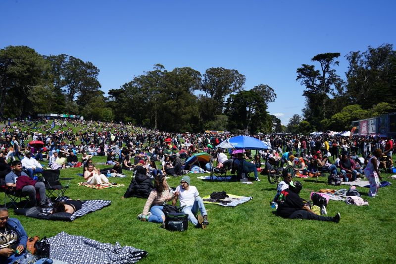 Groups of people lounge on the grass smoking weed at Hippie Hill in San Francisco.