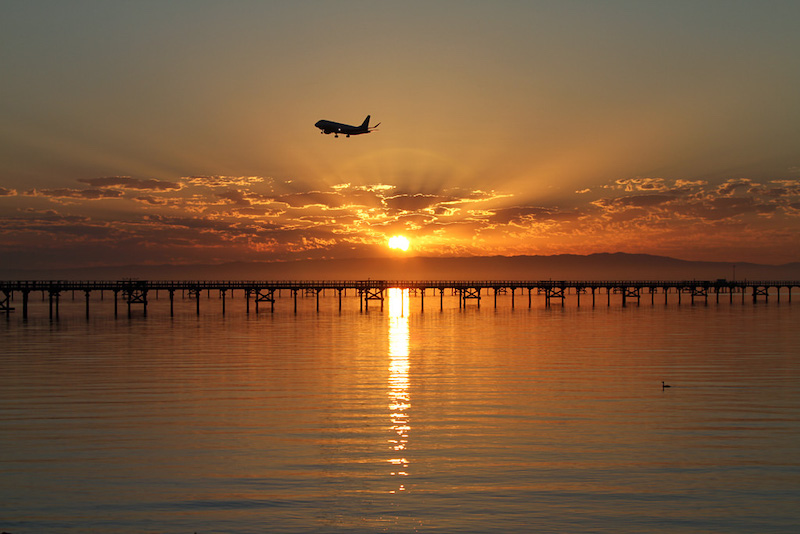 Plane taking off at sunrise