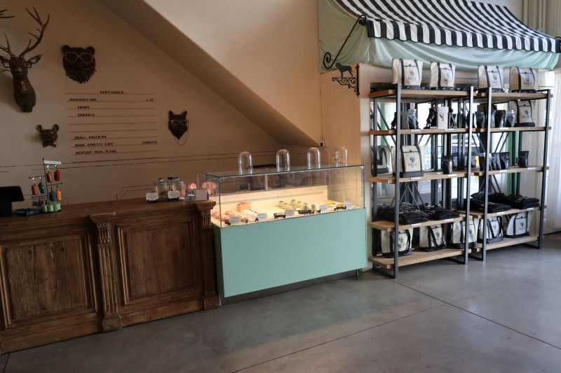 Interior of Dogue Cafe with pastry case, bagged dog food selection, and counter to order.