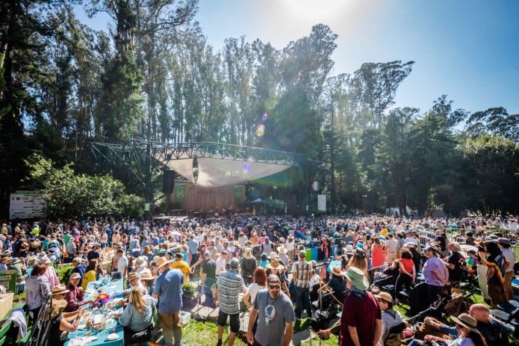 A crowd of people watches an outdoor concert at Stern Grove Festival in San Francisco.