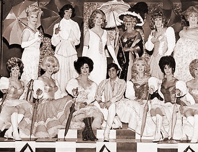 a cast on stage posing