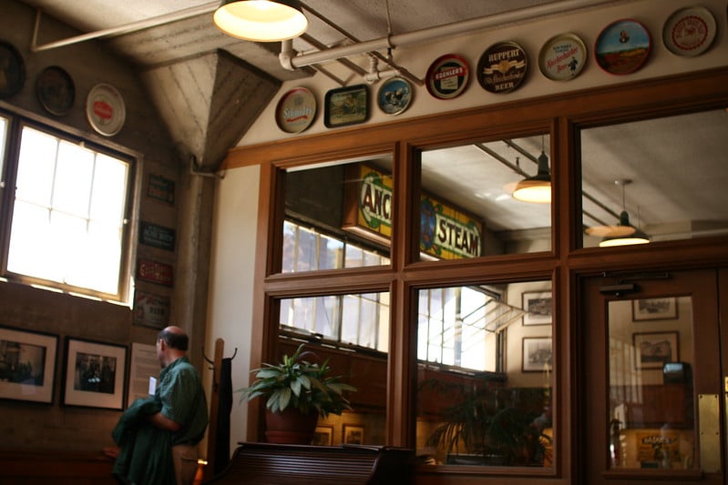 Tour inside the brewery featuring large windows and a bar setting.