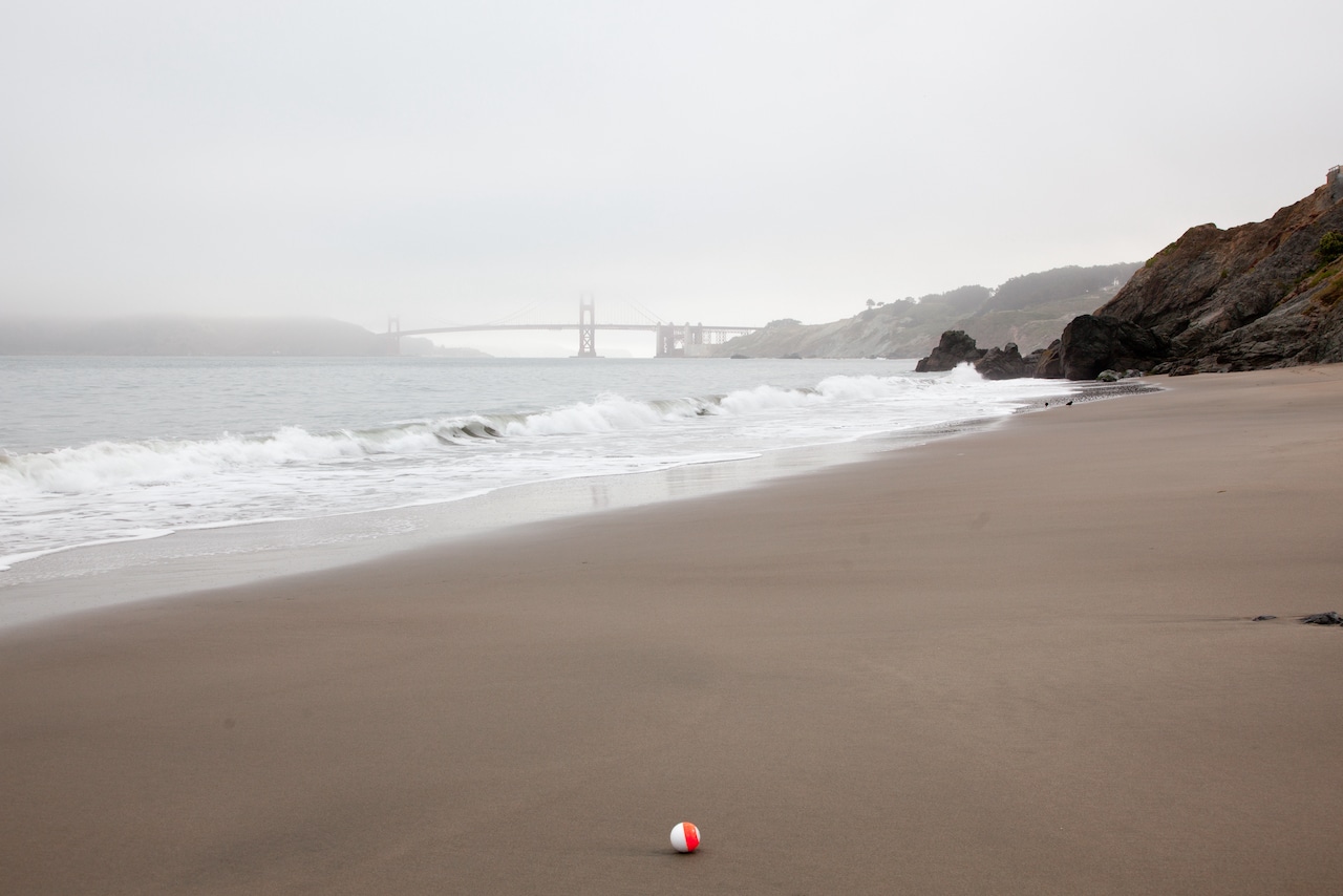 Foggy beach with the Golden Gate Bridge in the background
