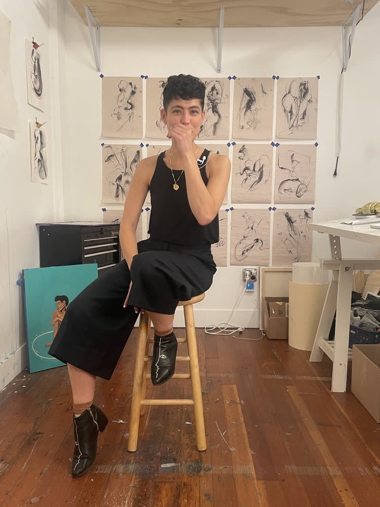 Artist Alma Landeta sitting on a stool
