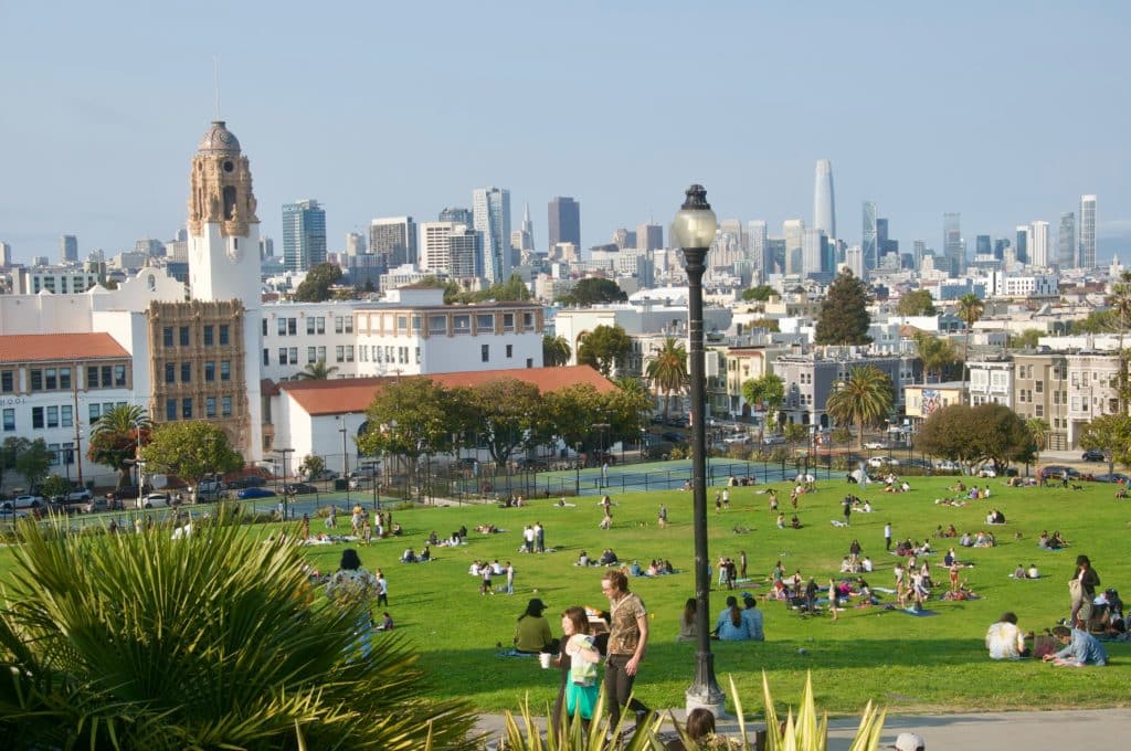 Dolores park with people on the grass.
