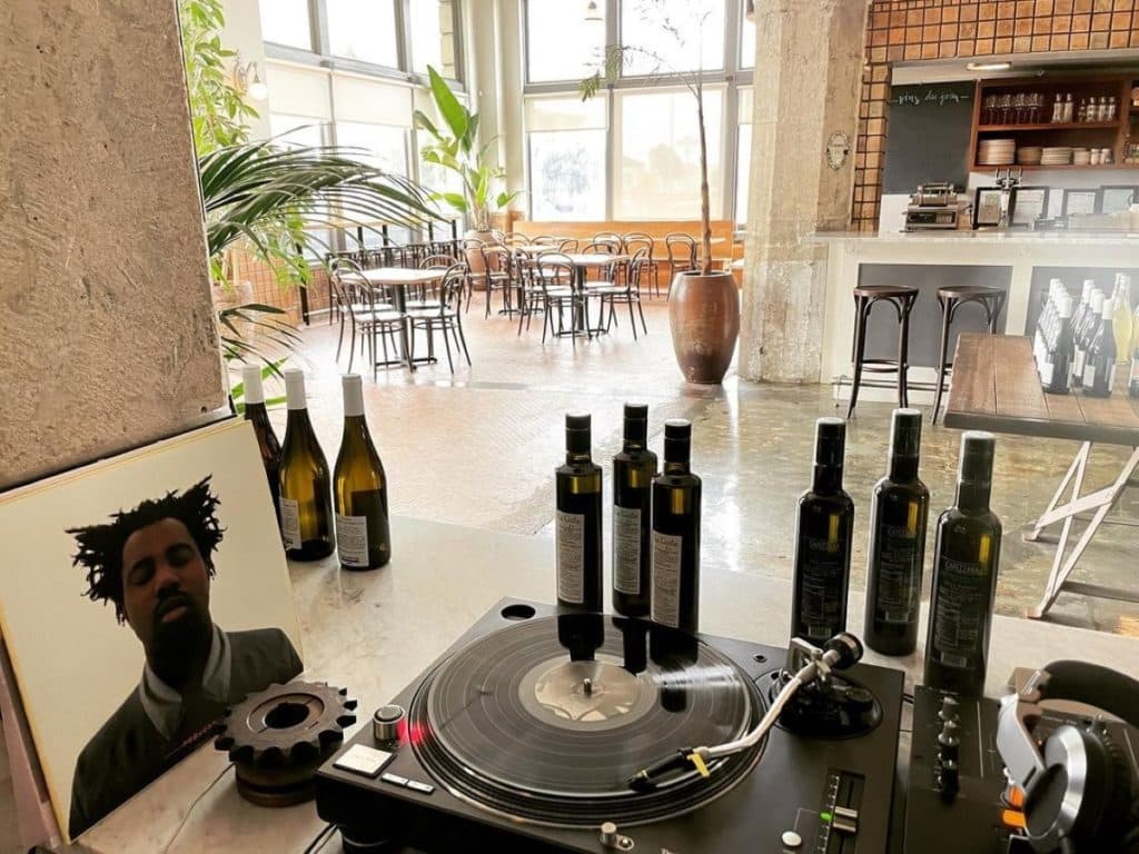 natural wine bar with wine bottles and record player.