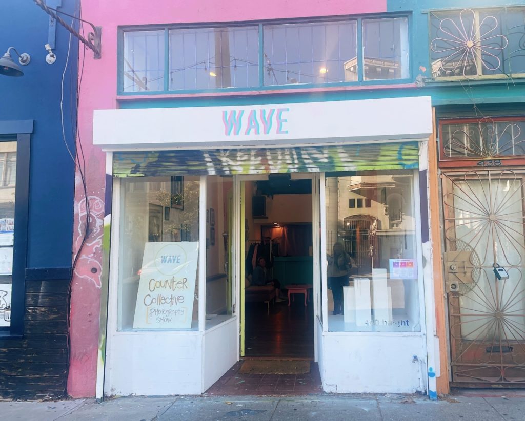A colorful storefront with the word wave above the door.