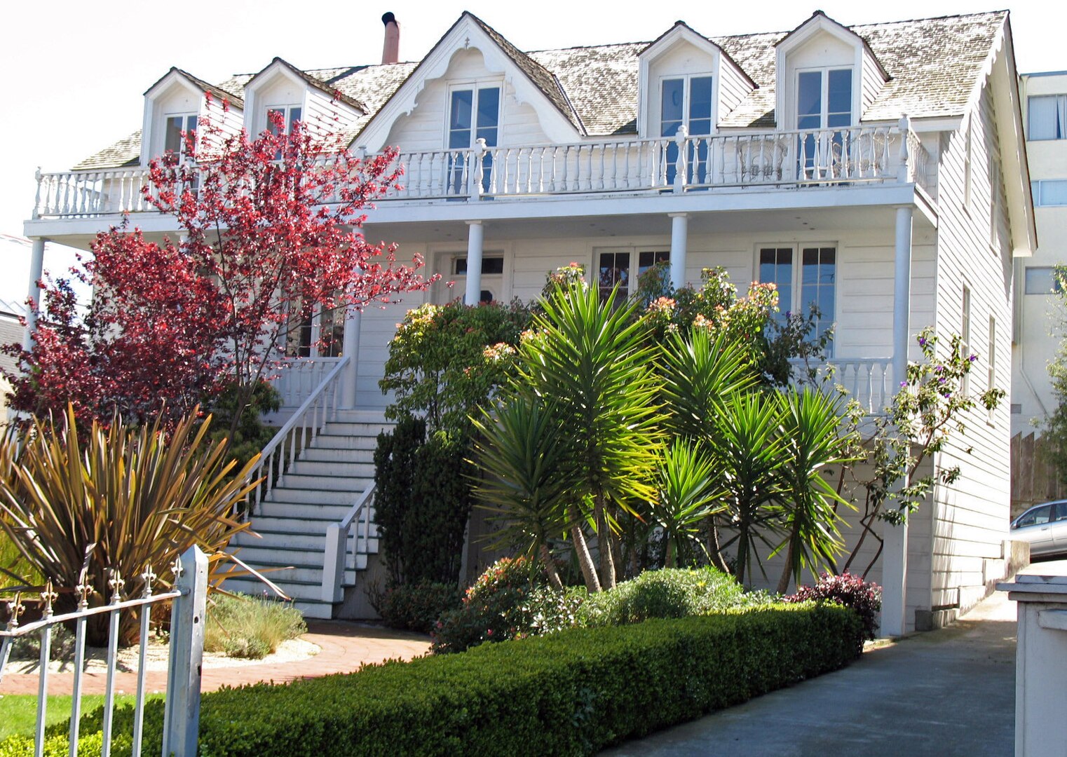the oldest house in San Francisco, a large white house with a porch.