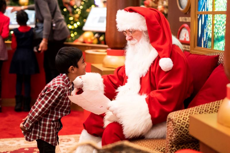 Santa talks to a child.